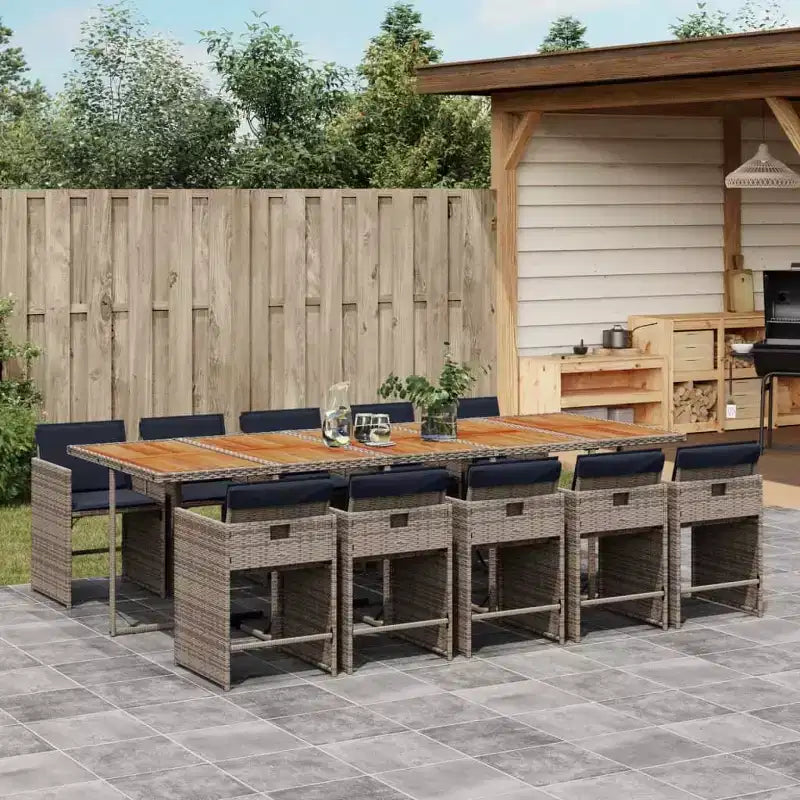 vidaXL Juego de comedor de patio de 11 piezas con cojines Muebles de jardín al aire libre Rota de polietileno gris, tablero de mesa de madera de acacia, cojines azul marino