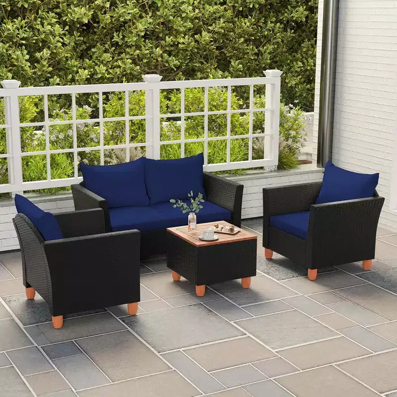 Juego de muebles de patio de mimbre Costway de 4 piezas con cojines extraíbles, mesa de centro de almacenamiento, blanco/azul marino/gris